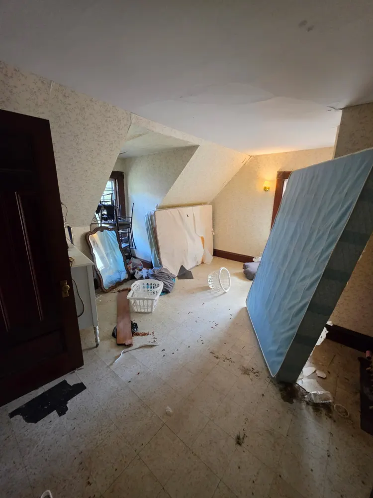 Before: upstairs room and mattress removed — Pioneer Valley Junk Removal job