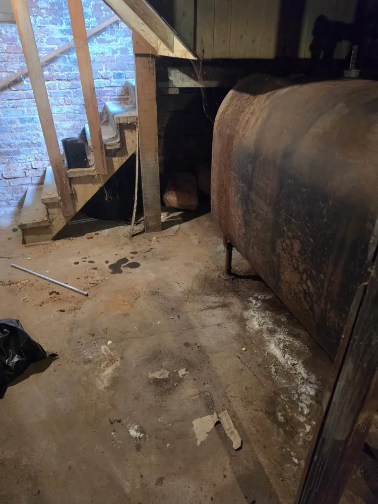 After: basement corner cleared around the oil tank — Pioneer Valley Junk Removal job