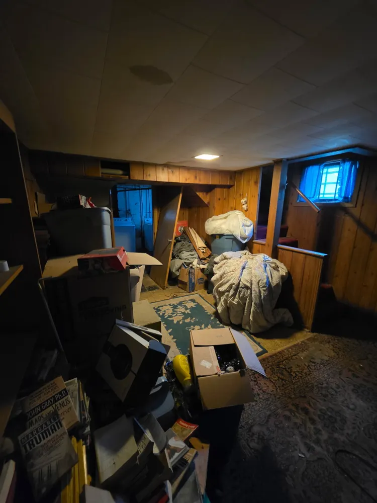 Before: wood-paneled basement emptied — Pioneer Valley Junk Removal job