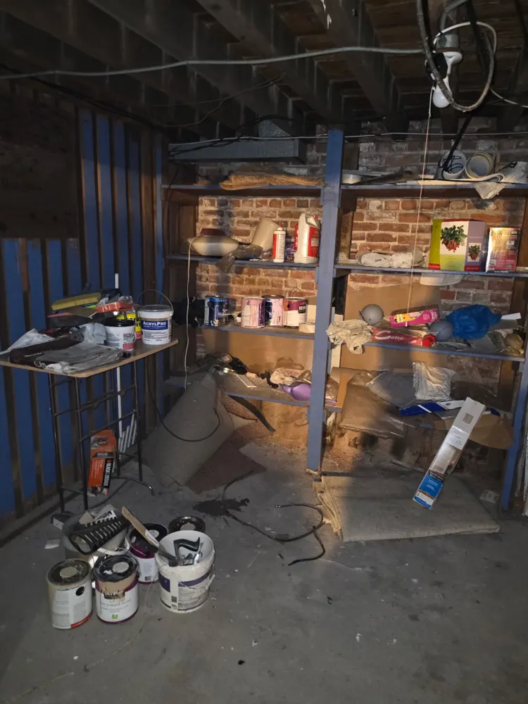 Before: basement shelves and floor cleared — Pioneer Valley Junk Removal job