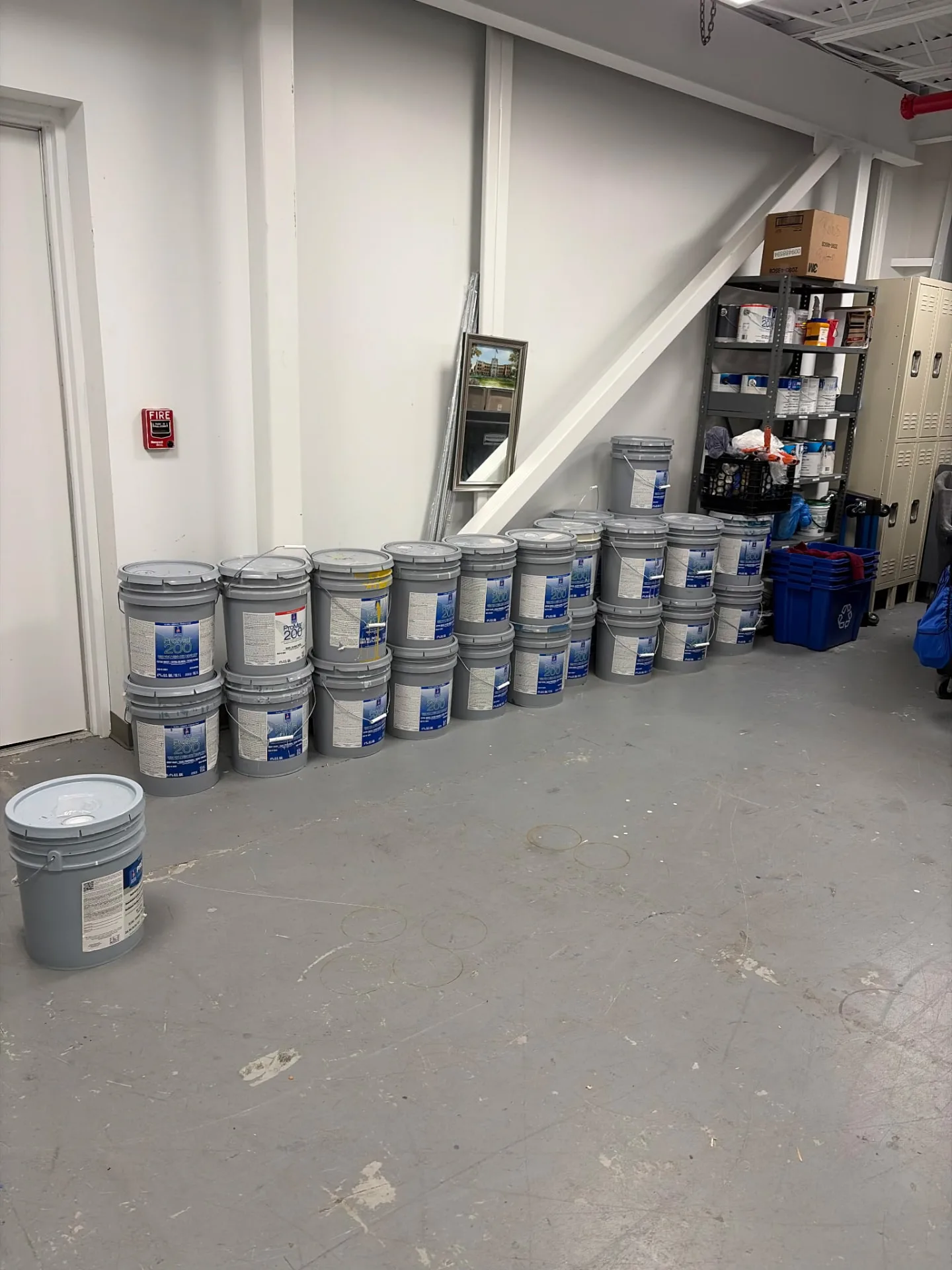 Rows of leftover paint cans hauled out of a charter school — Pioneer Valley Junk Removal job