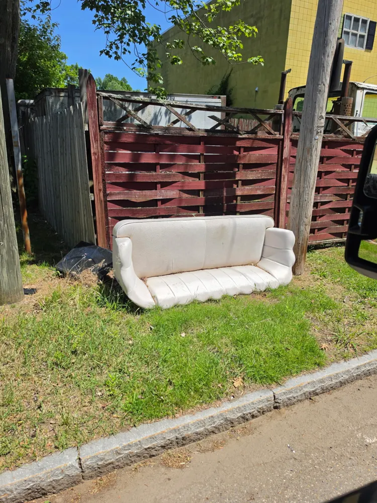 Before: curbside couch picked up — Pioneer Valley Junk Removal job