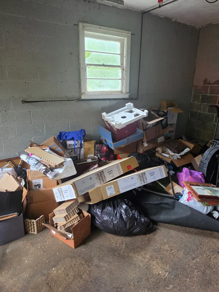 Before: storage room full of boxes, emptied — Pioneer Valley Junk Removal job